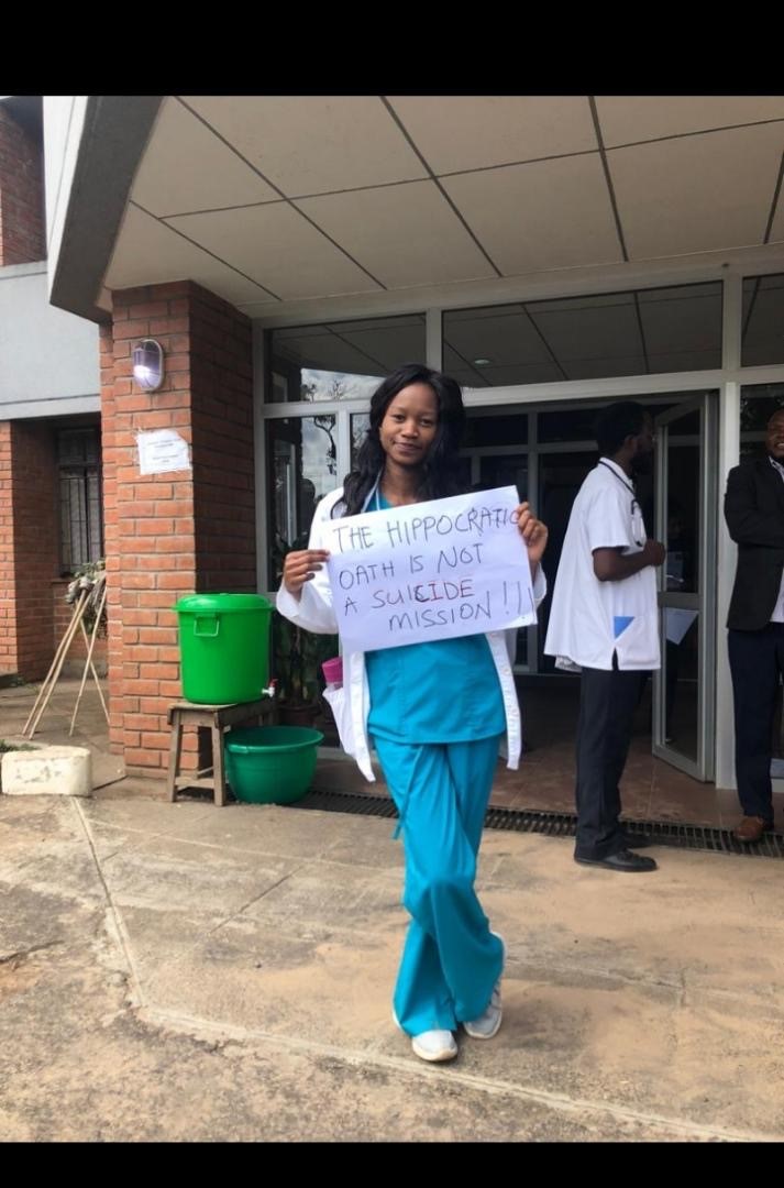 A healthworker holds up a placard during the national healthworkers strike_for_PPE_for COVID prevention
